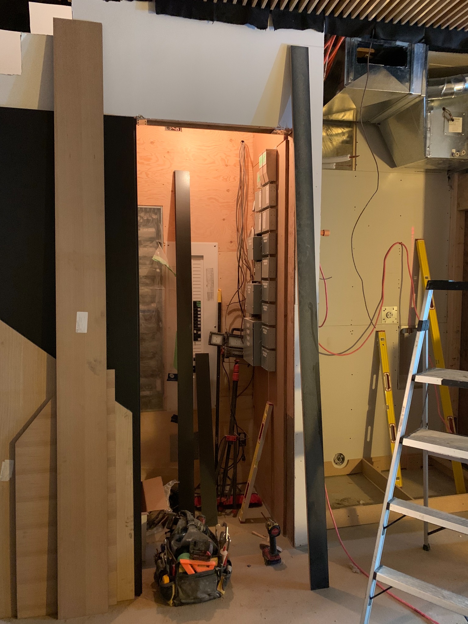 Custom panel-wall framing and installation around a utility space